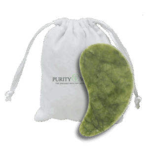 White drawstring pouch labeled "PURITY – THE ORGANIC HEALTHY ALTERNATIVE" next to a smooth, green jade gua sha tool used for facial massage and skincare.