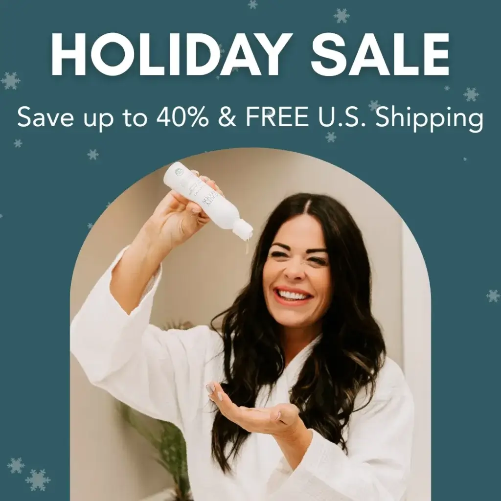 A woman in a white bathrobe smiles while pouring liquid from a white bottle into her hand. The background features a teal overlay with snowflake graphics, evoking a festive winter theme. Promotional text reads: "HOLIDAY SALE – Save up to 40% & FREE U.S. Shipping," highlighting a seasonal discount on a personal care product.