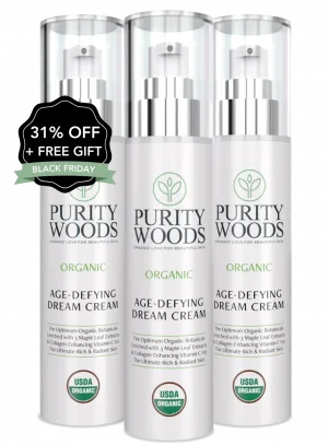 Three bottles of Purity Woods Age-Defying Dream Cream, each labeled with organic skincare claims and the USDA Organic seal. Product highlights include maple leaf extract and encapsulated vitamins C and E for radiant skin. A promotional badge on the leftmost bottle reads "31% OFF + FREE GIFT" and "BLACK FRIDAY."
